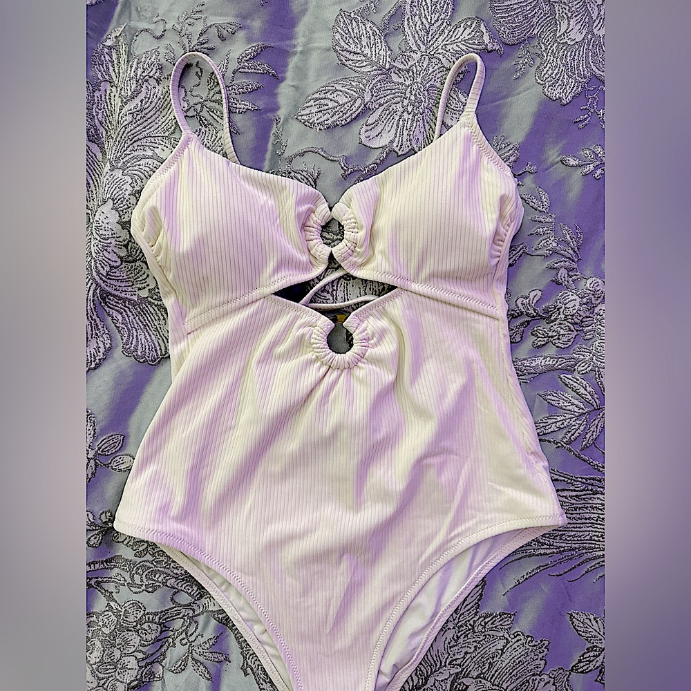 White one piece never used, only tried on. Never been worn or washed. NWOT